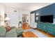 Bright living room featuring a blue accent wall and refinished hardwood floors at 1166 Virginia Avenue Northeast Ne Ave # 8, Atlanta, GA 30306
