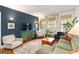 Cozy living room featuring a green sofa, blue accent wall, and hardwood floors at 1166 Virginia Avenue Northeast Ne Ave # 8, Atlanta, GA 30306