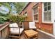 This is an image of a wooden patio area with outdoor furniture and a brick wall at 1166 Virginia Avenue Northeast Ne Ave # 8, Atlanta, GA 30306