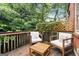 Wooden patio area with outdoor furniture surrounded by trees and greenery at 1166 Virginia Avenue Northeast Ne Ave # 8, Atlanta, GA 30306