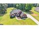 Beautiful aerial shot of a brick house with manicured lawn and landscaped front yard at 1032 Shumard Ln, Mcdonough, GA 30252