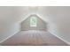 Spacious attic featuring carpet, neutral walls, and natural light from a window at 1032 Shumard Ln, Mcdonough, GA 30252