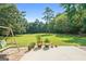 Green grass backyard with swing, plants and beautiful trees at 1032 Shumard Ln, Mcdonough, GA 30252