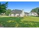 Spacious backyard featuring lush green grass and mature trees at 1032 Shumard Ln, Mcdonough, GA 30252