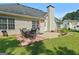 Backyard patio with table, chairs, grill and swing, perfect for outdoor dining at 1032 Shumard Ln, Mcdonough, GA 30252
