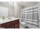 Bathroom features a dark vanity, a tub and shower combo, and modern fixtures at 1032 Shumard Ln, Mcdonough, GA 30252