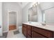 Bright bathroom features double vanity with cherry cabinets and a walk-in closet at 1032 Shumard Ln, Mcdonough, GA 30252