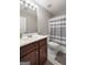 Bathroom features a dark vanity, a tub and shower combo, and modern fixtures at 1032 Shumard Ln, Mcdonough, GA 30252