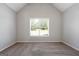 Bedroom featuring a vaulted ceiling, carpet, neutral walls, and natural light from a window at 1032 Shumard Ln, Mcdonough, GA 30252