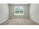Bedroom featuring plush carpet, neutral walls, and natural light from a window at 1032 Shumard Ln, Mcdonough, GA 30252