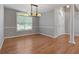 Dining room with hardwood floors and modern chandelier close to the foyer at 1032 Shumard Ln, Mcdonough, GA 30252