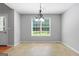 Sun-filled dining area with a decorative light fixture and large window offering natural light at 1032 Shumard Ln, Mcdonough, GA 30252