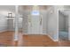Bright foyer with hardwood floors, white trim, columns, and an entry door at 1032 Shumard Ln, Mcdonough, GA 30252