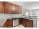 Kitchen features brown cabinets, stainless steel appliances, granite counters, tile backsplash and stainless sink at 1032 Shumard Ln, Mcdonough, GA 30252