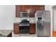 Modern kitchen showcases stainless steel appliances and matching microwave with granite counters at 1032 Shumard Ln, Mcdonough, GA 30252