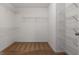 Large walk-in closet featuring carpet and metal racks for storage at 1032 Shumard Ln, Mcdonough, GA 30252