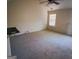 Bright bedroom with neutral carpet, a ceiling fan and a window with mini blinds at 7471 Garnet Dr, Jonesboro, GA 30236