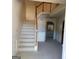 Inviting entryway with staircase, carpeted floors, and decorative wall accents at 7471 Garnet Dr, Jonesboro, GA 30236