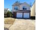 Two-story home with a brick-accented two-car garage and a well-maintained front yard at 7471 Garnet Dr, Jonesboro, GA 30236