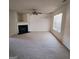 Spacious living room with plush carpeting, a fireplace, and a window offering natural light at 7471 Garnet Dr, Jonesboro, GA 30236