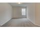 Cozy carpeted bedroom featuring a bright window and neutral walls at 4464 Eastbrook Pl # 56B, Snellville, GA 30039