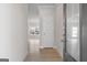 Welcoming entryway with light wood floors, white walls, and modern digital lock at 4464 Eastbrook Pl # 56B, Snellville, GA 30039