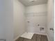 The laundry room features a utility sink, hookups, and waterproof wood-look flooring at 4464 Eastbrook Pl # 56B, Snellville, GA 30039