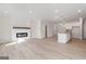 Open concept living room featuring modern fireplace, gourmet kitchen, and ample space at 4464 Eastbrook Pl # 56B, Snellville, GA 30039