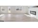 Bright living room with luxury vinyl floors, an electric fireplace, and plenty of natural light at 4464 Eastbrook Pl # 56B, Snellville, GA 30039