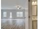 Spacious living room featuring new wood floors, modern ceiling fan, and backyard view at 4464 Eastbrook Pl # 56B, Snellville, GA 30039