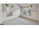 Bright, carpeted bedroom featuring charming wainscoting, multiple windows, and stylish window treatments at 1278 Discover Green Lane Ln # 7, Mableton, GA 30126