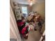 Bedroom filled with cardboard boxes, clothes, and various items, partially obscuring the window and furniture at 733 Stonehaven Chase, Mcdonough, GA 30253