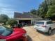 Exterior view of a home with a wide driveway, two parked cars, and an attached garage at 733 Stonehaven Chase, Mcdonough, GA 30253