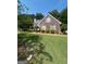 Charming single-story home with lush green lawn, mature trees, and well-maintained landscaping at 733 Stonehaven Chase, Mcdonough, GA 30253