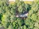 An aerial view of a secluded home tucked away among mature trees, offering privacy at 1000 Coan Dr, Locust Grove, GA 30248