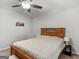 Comfortable bedroom featuring a wooden bed frame, ceiling fan, and bedside lamp at 1000 Coan Dr, Locust Grove, GA 30248