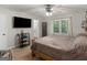 Comfortable bedroom featuring a ceiling fan, mounted tv, and en suite bathroom at 1000 Coan Dr, Locust Grove, GA 30248