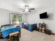 Shared bedroom with carpet flooring, a ceiling fan, and natural light from the windows at 1000 Coan Dr, Locust Grove, GA 30248