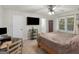 Comfortable bedroom featuring a ceiling fan, mounted tv, and en suite bathroom at 1000 Coan Dr, Locust Grove, GA 30248