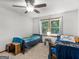 Bedroom featuring two twin beds, neutral carpet, and a ceiling fan for comfortable living at 1000 Coan Dr, Locust Grove, GA 30248