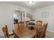 Bright dining room with six chairs and wooden table, neutral walls, and natural light at 1000 Coan Dr, Locust Grove, GA 30248