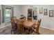 Bright dining room featuring a six-chair wooden table set and sunlit window at 1000 Coan Dr, Locust Grove, GA 30248
