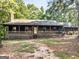Charming log cabin with spacious front porch, ideal for relaxing and enjoying nature at 1000 Coan Dr, Locust Grove, GA 30248