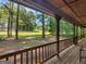 View from the front porch of mature trees and the surrounding yard at 1000 Coan Dr, Locust Grove, GA 30248