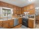 Traditional kitchen equipped with updated appliances, neutral cabinets, and natural light at 1000 Coan Dr, Locust Grove, GA 30248