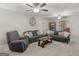 A seating area in the living room includes couches, a wooden table, and ceiling fans at 1000 Coan Dr, Locust Grove, GA 30248