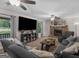 Spacious living room features plush seating, stone fireplace, and lots of natural light at 1000 Coan Dr, Locust Grove, GA 30248