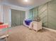 Cozy bedroom featuring a bed, a decorated accent wall, and natural light from a window at 116 Sophie Cir, Locust Grove, GA 30248