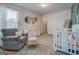 A calm Bedroom area featuring a crib, glider and dresser, perfect for peaceful moments at 116 Sophie Cir, Locust Grove, GA 30248