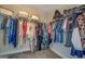 Spacious walk-in closet with ample hanging space and wire shelving for organized storage at 116 Sophie Cir, Locust Grove, GA 30248
